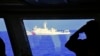 FILE - In this photo provided by the Philippine Coast Guard, a Chinese Coast Guard ship sails near a Philippine Coast Guard vessel during its patrol at Scarborough Shoal, March 2, 2022. 