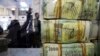 FILE - A stack of Yemeni riyals rests on the counter at the Central Bank of Yemen's internationally recognized government, in Aden, Yemen, Dec. 13, 2018.