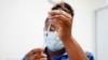 FILE - A nurse prepares a dose of COVID-19 vaccine at the University Hospital Coventry, in Coventry, England, April 22, 2022.