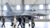 Ukrainian President Volodymyr Zelenskyy, second right, and Dutch caretaker Prime Minister Mark Rutte, center, look at F-16 fighter jets in Eindhoven, Netherlands, Aug. 20, 2023. 