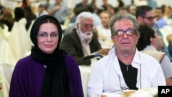 FILE - In this photo taken on July 7, 2015, and provided by the Iranian Students' News Agency, ISNA, Iranian film director Dariush Mehrjui and his wife, Vahideh Mohammadifar attend a film directors' meeting in Tehran, Iran.