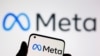 FILE - A smartphone with Meta logo is seen in front of displayed Facebook's new rebrand logo Meta in this illustration taken Oct. 28, 2021. 