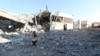 A girl stands amidst debris after Russian airstrikes hit an abandoned water pumping station in Syria's rebel-held northwest, on August 23, 2023. 