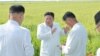This undated picture released from North Korea's official Korean Central News Agency (KCNA) on Aug. 18, 2023, shows North Korea's leader Kim Jong Un, center, inspecting restoration activities at a farm in Anbyon-gun, Kangwon province, which was recently damaged by a typhoon.