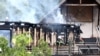 Petugas pemadam kebakaran memeriksa bangunan yang terbakar setelah terjadi kebakaran di sebuah rumah peristirahatan bagi penyandang disabilitas di Wintzenheim, Prancis timur, 9 Agustus 2023. (Foto: AFP)