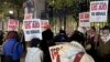 Pro-Palestinian protesters demonstrate outside the main gate at Columbia University, in New York, early April 26, 2024.