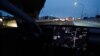 FILE - A Tesla Model 3 vehicle drives on autopilot along the 405 highway in Westminster, California, March 16, 2022. 