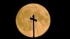 The August super blue moon sets behind the St. Basil's Cathedral in Red Square in Moscow, Russia, Aug. 30, 2023. 