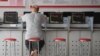 FILE - An investor looks at screens showing stock market movements at a securities company in Fuyang in China's eastern Anhui province, May 29, 2023. China halved the stamp duty on securities transactions, to take effect Monday, state media reported, Aug. 27, 2023.