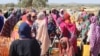 FILE - Refugees fleeing the conflict in Sudan, including violence in its western Darfur region, queue with jerrycans to collect drinking water from a distribution point at the Ourang refugee camp in Adre, Chad, on Dec. 7, 2023.