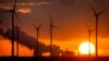 FILE - Steam rises from the coal-fired power plant near wind turbines Niederaussem, Germany, as the sun rises on Wednesday, Nov. 2, 2022. 