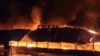 Para petugas pemadam kebakaran berupaya memadamkan api di supermarket usai serangan pesawat nirawak (drone) Rusia di Kota Odesa, Ukraina, Senin, 14 Agustus 2023. (Foto: Pasukan Pertahanan Selatan Ukraina/Reuters)