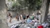 Palestinians inspect the site of an Israeli strike on a house in Rafah, in the southern Gaza Strip, April 25, 2024.