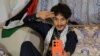 Rashed Al-Haddad, 19, a Yemeni TikToker and influencer, who has been dubbed 'Tim Houthi Chalamet' by Western internet wags for his resemblance to actor Timothee Chalamet, talks to a friend on the phone in Sanaa on Jan. 18, 2024.