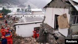 Rescue workers search for survivors near damaged houses after a landslide hit Liangshui village in Zhenxiong county of Zhaotong, Yunnan province, China, Jan. 23, 2024. (cnsphoto via Reuters)