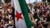 FILE - A girl raises the Syrian opposition flag in Idlib, Aug. 25, 2023, in support of anti-government protests in the southern city of Sweida. More protests occurred March 1, 2024, across Syria's northwest against that region's jihadi rulers.