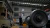 FILE - A worker checks on a cargo train wheel at the GEMAC Engineering Machinery, a China-based company, during a media-organized tour in Xiangyang in central China's Hubei Province, May 10, 2023. 