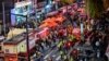 Onlookers, police and paramedics gather where dozens of people suffered cardiac arrest, in the popular nightlife district of Itaewon in Seoul on Oct. 30, 2022. 