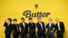 FILE- Members of South Korean K-pop band BTS, V, SUGA, JIN, Jung Kook, RM, Jimin, and j-hope from left to right, pose for photographers ahead of a press conference to introduce their new single "Butter" in Seoul, South Korea, May 21, 2021.