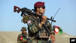 Afghan National Army soldiers stand guard at a checkpoint on the outskirts of Kabul, Afghanistan, Aug. 21, 2017.