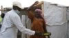 Un agent de sécurité fouille une femme au camp de réfugiés de Minawao à Minawao, au Cameroun, le 15 mars 2016.