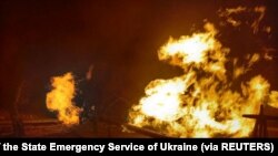 Facilities of a complex that prepares natural gas for transportation are pictured in a fire after night shelling, as Russia's attack on Ukraine continues, in the village of Hlazunivka in Kharkiv region, Ukraine, in this handout picture released March 13,