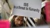 FILE - An Indian Muslim man holds a banner during a protest against IS, an Islamic State group, and the Paris attacks, in New Delhi, India, Nov. 18, 2015.