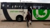FILE - Laborers disembark a Palestinians-only bus before crossing through Israel's Eyal checkpoint as they returns to the West Bank, near Qalqilya.