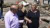 Chile's President Michelle Bachelet (r) talks to residents in a destroyed area of Concepcion, some 100 km (62 miles) south of the epicenter of a huge 8.8-magnitude earthquake that rocked Chile on February 27, 2010