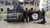 FILE - Iraqi security forces hold an Islamic State flag upside down in Anbar, Iraq, July 26, 2015, following the liberation of the city from IS militants. Pushing IS militants from their home turf will open a whole new challenge, experts caution.