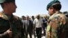 Ali Haidar Gilani son of a former Pakistani prime minister, right, walk with Pakistan Ambassador Abrar Hussain, left, as he arrives at the Ministry of Defense in Kabul, Afghanistan, Wednesday, May, 11, 2016.