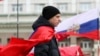 A participant wears a Russian flag during a pro-Russian rally outside the regional administration in Donetsk, March 17, 2014. 