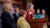 Sen. Elizabeth Warren, D-Mass., center, accompanied by fellow Democratic Women Senators, speaks during a news conference on Capitol Hill in Washington, Jan. 30, 2014, to show their support on raising the federal minimum wage.