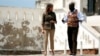 U.S. first lady Melania Trump walks through a courtyard during a visit to Cape Coast castle, Ghana, October 3, 2018. 