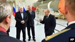Russian President Vladimir Putin, right, Belarusian President Alexander Lukashenko, left, and Russian Roscosmos head Dmitry Rogozin visit the Vostochny cosmodrome outside the city of Tsiolkovsky, about 200 kilometers (125 miles) from the city of Blagovesh