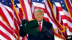 FILE - President Donald Trump gestures as he arrives to speak at a rally on Jan. 6, 2021, in Washington. 