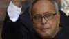 Indian Finance Minister Pranab Mukherjee (C) waves as he arrives at his office before leaving for Parliament to present Budget in New Delhi, File.
