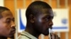 A man holds his identity book as he waits to cast his vote in Eden Park, south of Johannesburg, May 7, 2014.