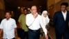 FILE - Malaysian opposition leader Anwar Ibrahim (C) and his wife Wan Azizah arrive at a court house in Putrajaya, March 7, 2014. 