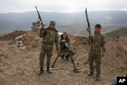 FILE - Armenian soldiers pose near a front line in Nagorno-Karabakh, Azerbaijan, April 6, 2016.