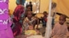 A family of refugees from Central Africa sit under a tent with their new baby, born in Cameroon two weeks ago, at an UNHCR refugee camp in the eastern Cameroonian city of Garoua-Boulai, not far from the border with Central Africa, March 13, 2014. 