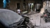 Medics inspect the damage outside a field hospital after an airstrike in the rebel-held al-Maadi neighbourhood of Aleppo, Syria, Sept. 28, 2016. 
