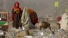 Afghan refugees girls collect recycle-able goods from a garbage to sell and earn living for their families in Peshawar, Pakistan, Feb. 5, 2016.