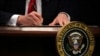 U.S. President Donald Trump signs an executive action he said would begin the rebuilding of the U.S. military by "developing a plan for new planes, new ships, new resources and new tools for our men and women in uniform" at the Pentagon in Washington, D.C., Jan. 27, 2017.