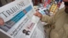 A man reads a newspaper containing news about Afghan Taliban leader Mullah Akhtar Mansour at a stall in Peshawar, Pakistan, May 23, 2016. 