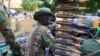 FILE - A South Sudanese army soldier stands next to a machine gun mounted on a truck in Malakal town, some 500 km (312 miles) northeast of the capital, Juba.