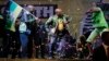 The ruling party president Jacob Zuma, center, sings and dances, at a victory party downtown Johannesburg, South Africa, following the announcement of the results for the 2014 national election result Saturday May 10, 2014