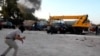 Libyans run for cover after fighting broke out outside the office of Libya Shield pro-government militia in Benghazi, Libya. June 8, 2013 (AP/APTV)