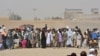 People en route to Afghanistan wait at the Pakistani border post in Chaman, in southwest Pakistan, Aug. 31, 2016. 