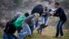 Palestinians carry an injured man during clashes with Israeli soldiers outside the Ofer military prison near the West Bank city of Ramallah, Jan. 2, 2015.